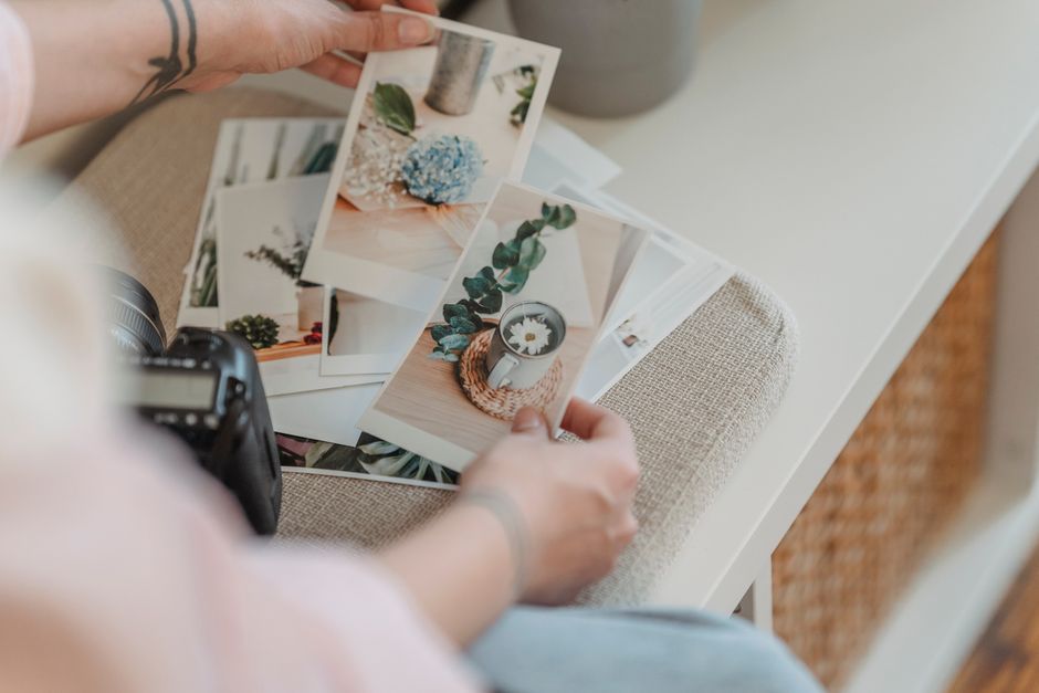 A camera and prints on a desk