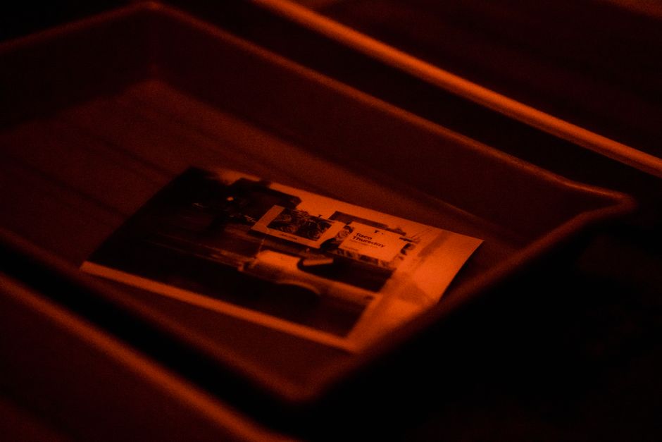 Prints being made in a darkroom